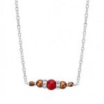 collier une perle de 5mm de véritable corail rouge de Méditerranée habillée de cristal de swarovski et perles d'hématite, montées sur chaine jaseron argent 925/1000