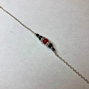 collier une perle de 5mm de véritable corail rouge de Méditerranée habillée de cristal de swarovski et perles d'hématite, montées sur chaine jaseron argent 925/1000